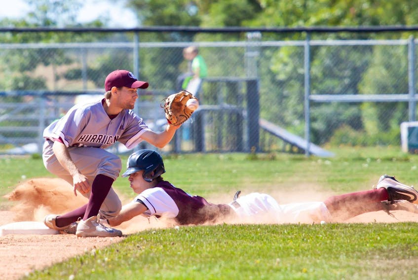 Holland College Hurricanes second baseman Matt Barlow, a Summerside native, receives a throw from catcher Chasse Gallant as a Saint Mary’s Huskies player steals second Saturday at Memorial Field.