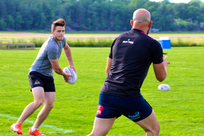 Summerside native Tyler Jurkowski, left, passes to a P.E.I. Mudmen teammate during Thursday’s practice in Charlottetown. Jurkowski and the Mudmen face the Dartmouth PigDogs Saturday in Summerside in Nova Scotia Senior Men’s Rugby League action.