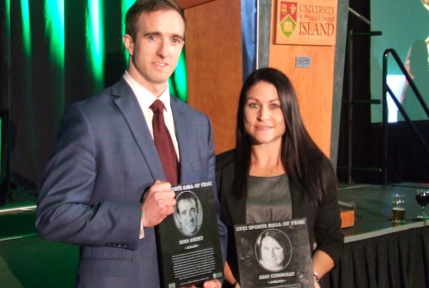 Former UPEI Panthers soccer standouts Ryan Anstey and Amy Connolly hold their plaques after being inducted into the UPEI Sport Hall of Fame Thursday in Charlottetown.