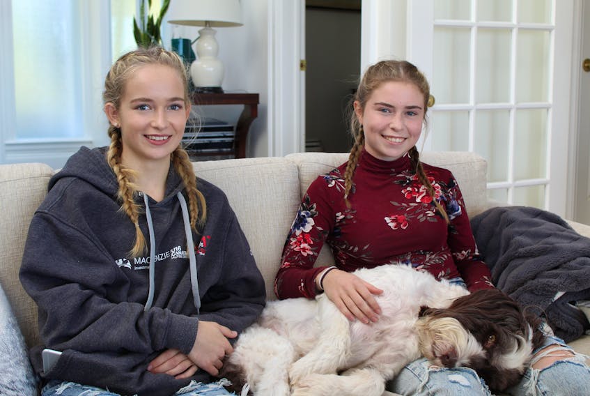 Sisters Makena, left, and Macy Cudmore (pillowed by family dog Levi) are part of P.E.I.’s resurgent sailing scene. The pair teamed to run a 29er racing skiff in various meets this past summer including being the first sailers from P.E.I. almost a decade to compete at the 29er North Americans regatta in Kingston, Ont. Macy, 15, is the skipper, while Makena, 17, is the forward.