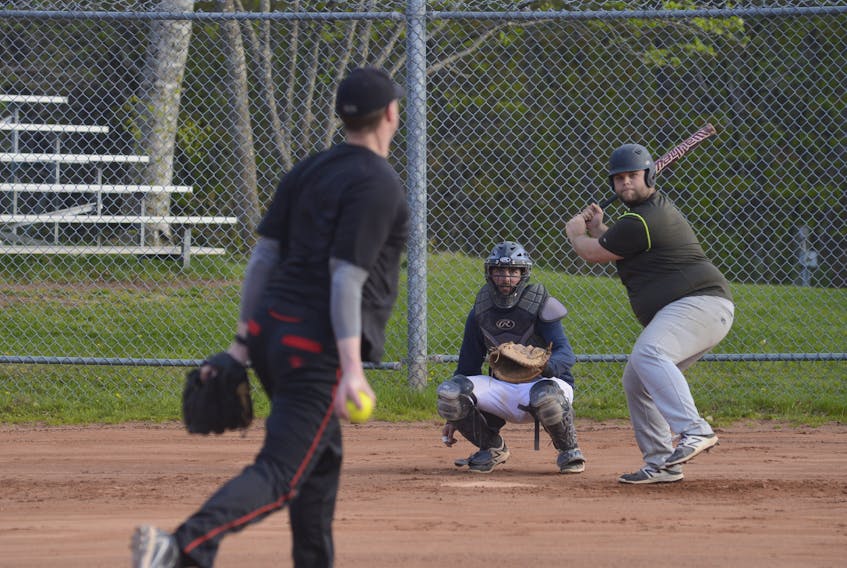 Stephen O’Shea prepares to take a swing at a pitch from Steven Noonan as catcher Parker Ronahan awaits the delivery during a recent batting practice for the Kevin Quinn Re/Max Ravens.