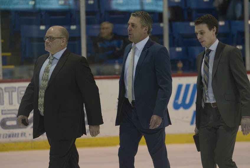 Jim Hulton, centre, general manager and head coach of the Charlottetown Islanders, will be busy today at the Quebec Major Junior Hockey League draft. He’s pictured here with Guy Girouard, left, assistant general manager and assistant coach, and Brad MacKenzie, assistant coach.