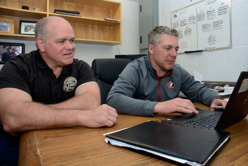 Islanders assistant general manager Guy Girouard, left, and general manager Jim Hulton have been busy going over draft scenarios in advance of Saturday’s Quebec Major Junior Hockey League draft.