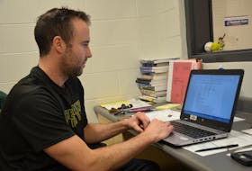 Three Oaks Senior High School athletic director Joel Arsenault checks over one of the schedules he has drawn up for the 23rd annual David Voye Memorial rugby tournament in Summerside this weekend. The status of the 10 Nova Scotia teams was still unknown by deadline time Monday.