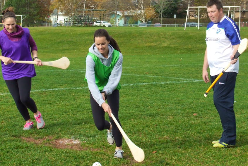 Montague Regional High School phys-ed teacher Natasha Nabuurs, centre, maneuvers between P.E.I. Gaelic Athletic Association president Shane O’Neill, right, and Westwood Primary phys-ed teacher Jacki Ross, left, at a recent hurling demonstration held by the PEIGAA at Colonel Gray High School in Charlottetown.