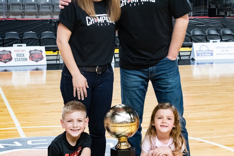 The Salernos pose with the National Basketball League of Canada trophy in 2019. Joe Salerno was the head coach of the Moncton Magic. With Joe are his wife, Darci Salerno, and their children, nine-year-old Camden and his six-year-old sister Alex. Jacinthe Leblanc/Special to The Guardian - Contributed