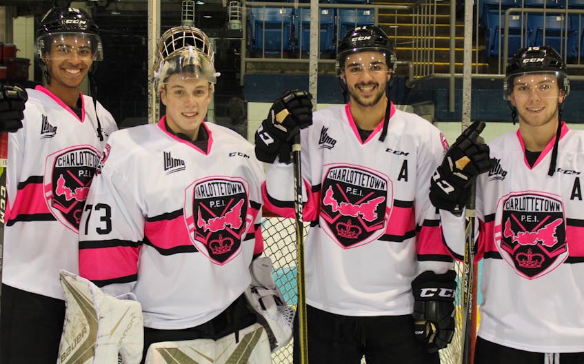The Charlottetown Islanders including, from left, captain Pierre-Oliver Joseph, goalie Matthew Welsh, and forwards one Pascal Aquin and Keith Getson will wear Pink the Rink jerseys for Saturday’s game versus Rouyn-Noranda. Fans can buy a raffle ticket or place a bid in a silent auction for a chance to win one of the game-worn jerseys.