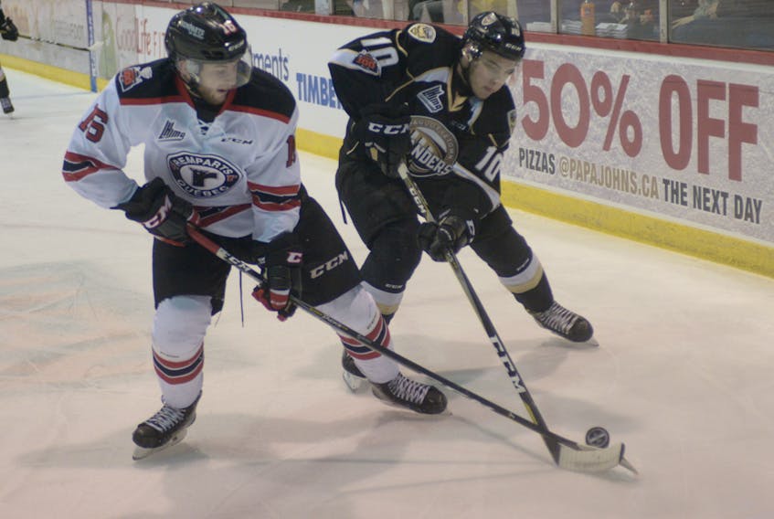 Charlottetown Islanders forward Brett Budgell, right, battles for the puck with Quebec Remparts defenceman Christian Huntley during Game 3 Quebec Major Junior Hockey League action Wednesday night at the Eastlink Centre in Charlottetown.