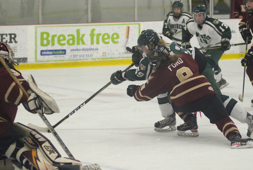 UPEI Panthers forward Lindsay Johnston fends off Mount Allison Mounties defenceman Rhiannon Ford during first period action of Saturday’s Atlantic University Sport women’s hockey game at MacLauchlan Arena.