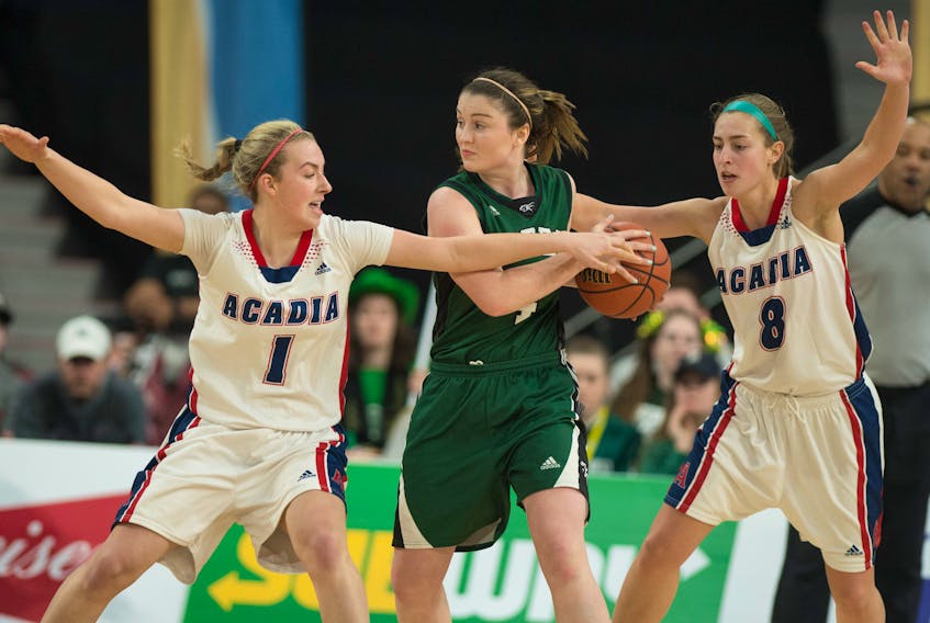 Acadia’s Ellen Hatt, left, and Katie Ross, right, defend against UPEI Panthers point guard Jenna Mae Ellsworth Sunday during the Atlantic University Sport (AUS) women’s basketball final at the Scotiabank Centre. Ryan Taplin/The Chronicle Herald
