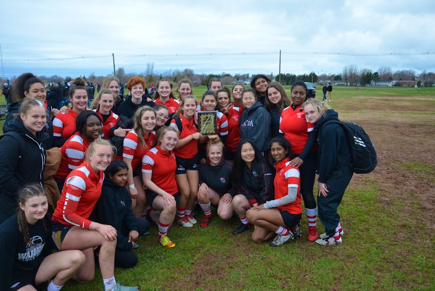 The Halifax West girls pose for a team photo after being named the inaugural recipient of the Brodie McCarthy Award at the 23rd annual David Voye Memorial rugby tournament at Three Oaks Senior High School on Saturday afternoon.