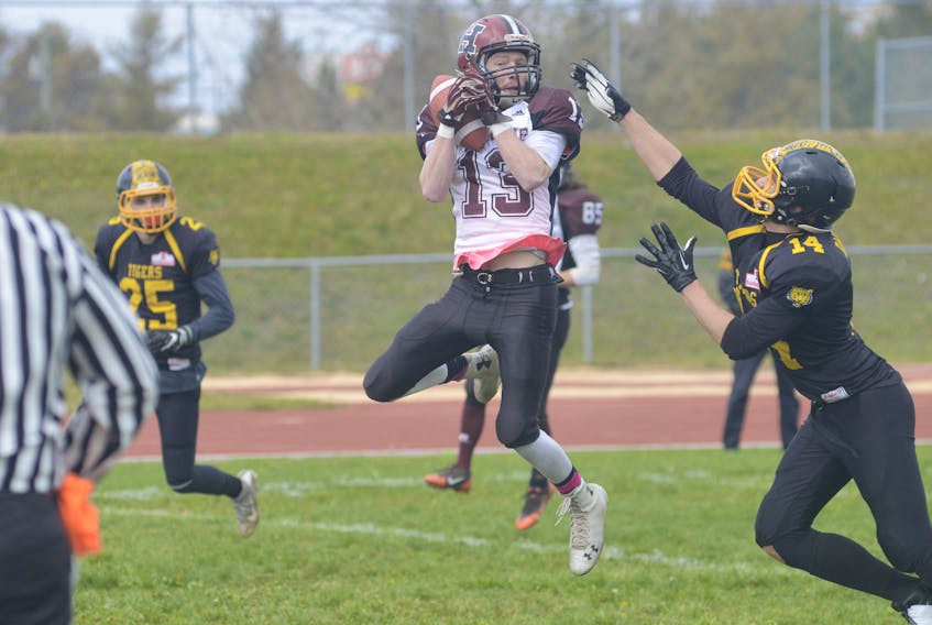 Holland College Hurricanes receiver Tyler Majuary hauls in a first quarter touchdown pass behind Dalhousie Tigers defensive back Gordon Brown Saturday during Atlantic Football League semifinal action in Charlottetown.