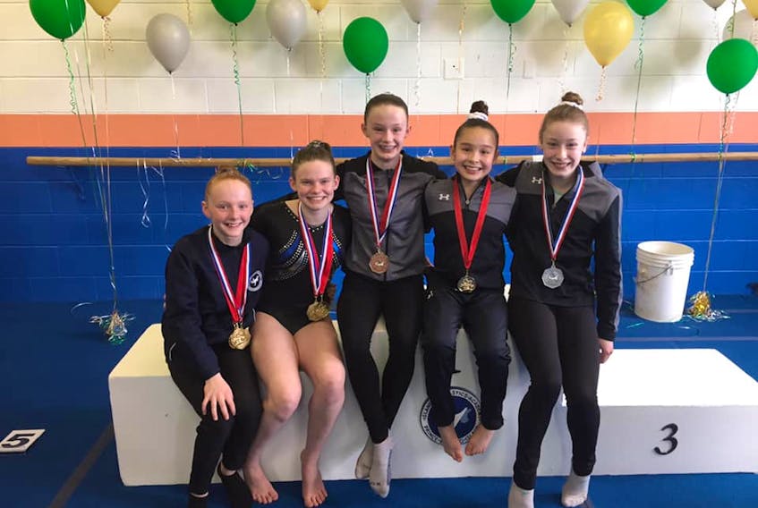 Five gymnasts confirmed their qualification for the national championships which will be held in Ottawa from May 21-26. The five happy gymnasts who will be representing P.E.I. are, from left, Victoria Covey, Sophie Mayne (both Island Gymnastics Academy), Molly McKenna, Maia MacLean and Chloe Cudmore (all Victory Gymnastics Centre). Cameron Davis and Ian McKenna from IGA will also represent P.E.I. in the boys’ competition. Kristi Shoemaker, Shelley Ferguson and C.J. Keliher will be the coaches.
