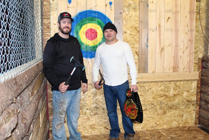 Ian MacDonald, left, and Ryan MacMillan, co-owners of Chuck Hatchets in Charlottetown, stand in the cage where axes will be thrown.