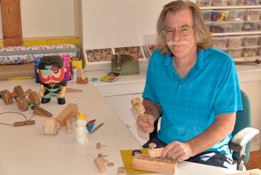 Dan Viau works on one of the hand-crafted wooden toys available for sale at The Toy Factory store he owns with his wife Kathy in New Glasgow.