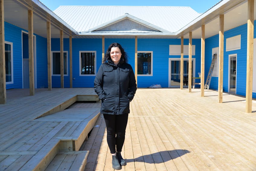 Miranda Ellis, owner of The Ship’s Company Pub and Galley, stands in front of the location of the new restaurant in one of the buildings built over the winter at Mariner’s Cove Boardwalk.