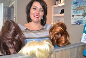 Carla Wilson MacKinnon shows a few of the wigs she’s collected that will go to women fighting cancer. The Charlottetown stylist started the wig exchange as a tribute to her late mother. (SALLY COLE/THE GUARDIAN)