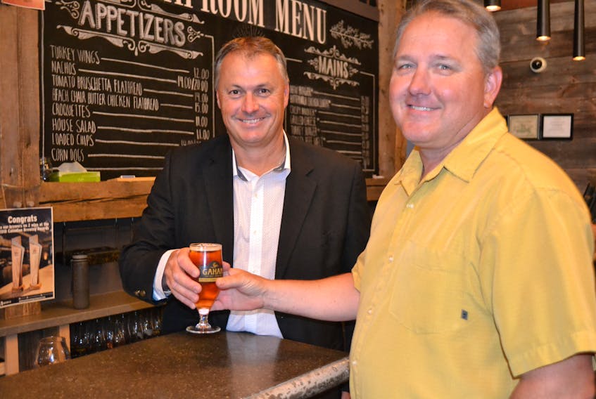 Jeff Squires, president of the P.E.I. Brewing Company, serves a cold one to Shane MacDougall prior to Thursday’s government funding announcement. ACOA is providing a $500,000 repayable contribution to the P.E.I. Brewing Company to help renovate its existing facility and purchase new brewing equipment. The P.E.I. government is also providing $754,132 in repayable financing to assist with an expansion.