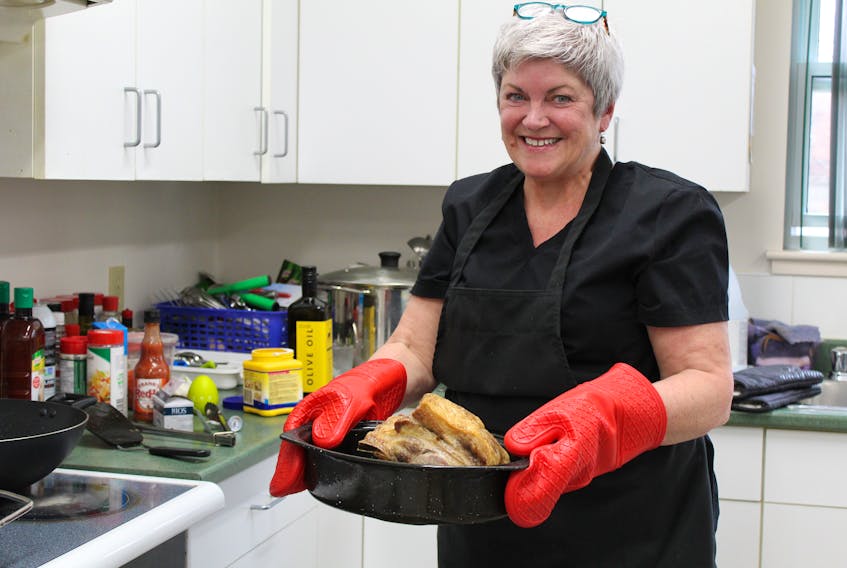 Janet Ford, owner of Comfort Food by Janet, takes a roast out of the oven at St. Mark’s Presbyterian Church in Charlottetown earlier this month. Ford prepares food for pick up or delivery on Tuesdays, Wednesdays and Thursdays each week.