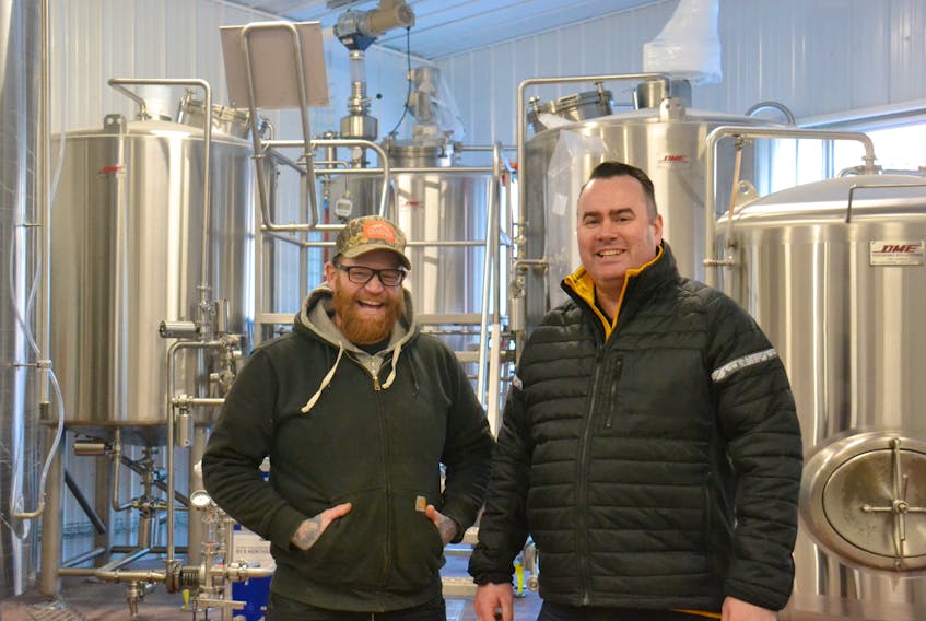 Chef Dave Mottershall, left, and Bogside Brewing owner David McGuire stand in front of some of the equipment at the Montague brewery, which is set to open this spring.