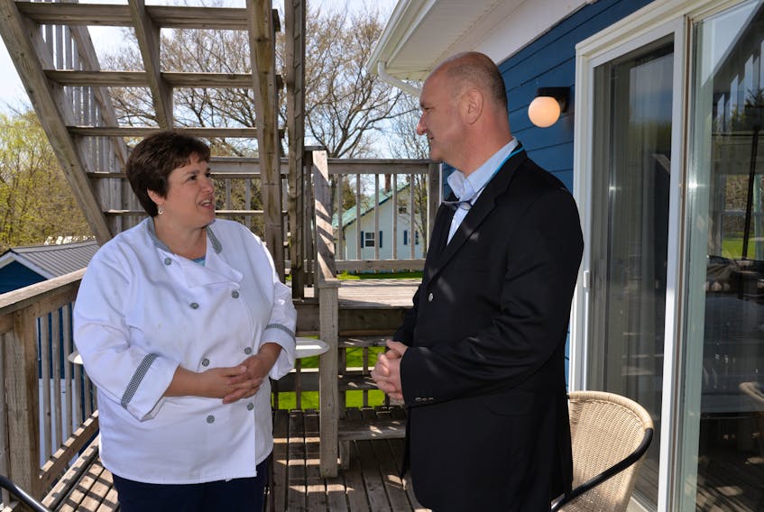 Rhonda Brown, owner of the Georgetown Inn, and visitor Tolga Toprak discuss business in the community at a recent P.E.I. Connectors bus trip to Georgetown.
