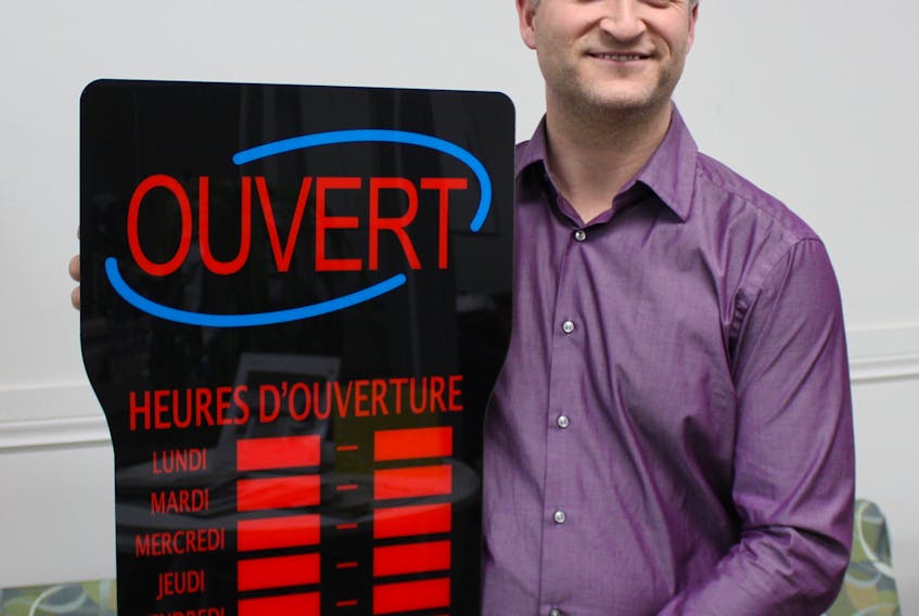 Pierre Gallant, owner of HMS Office Solutions in Summerside, shows one of the LED signs he sells to help francophone and bilingual businesses show visitors they offer services in French. Submitted photo