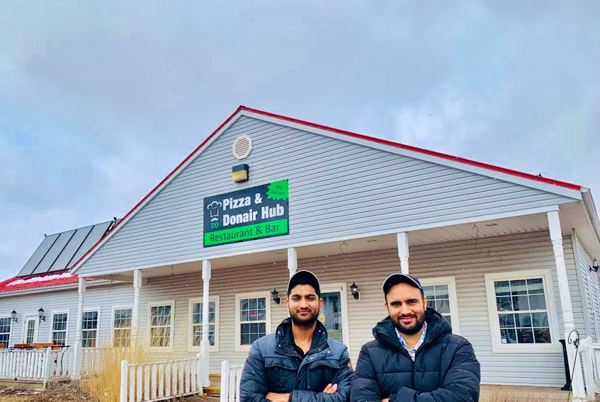 Deepanshu Garg, left, and Dharminder Shergill prepare for the grand opening at Pizza and Donair Hub’s newest location at the former Maggie’s restaurant opposite the Quality Inn in Cornwall.