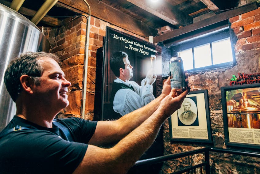 Gahan House brewer and partner Trent Hayes examines a can of Trent Hayesy IPA, a new brew launched by the P.E.I. Brewing Company to pay tribute to its longtime brewmaster.