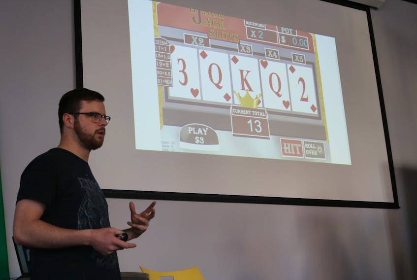 Reilly Webster presenting his group’s concept for a Black Jack and Slots hybrid lottery game during the Atlantic Lotto Super Hackathon held at Startup Zone over the weekend.