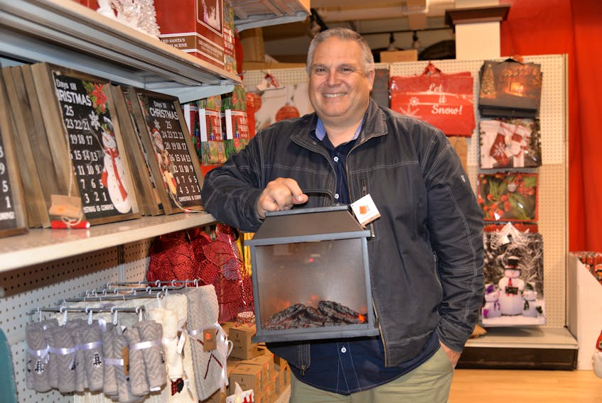 Greg Butler, owner of Christmas Discounters, holds one of the store’s new products this year – an LED glowing fireplace. Butler has re-opened the seasonal store in the Charlottetown Mall, and by the end of the month is opening a new permanent, year-round store in Stratford.