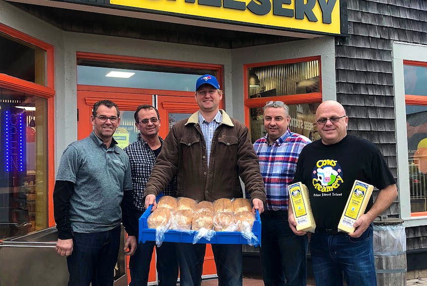 Moo Moo Grilled Cheesery farmers and producers, from left, Harvey Larkin of Larkin Brothers Poultry, Al MacLean of Al’s Bacon, Bill Deblois of Buns and Things Bakery, Dwayne MacQuarrie of MacQuarrie’s Meats, and Armand Bernard of Cows Creamery were on hand to celebrate the cheesery’s first year-round location.