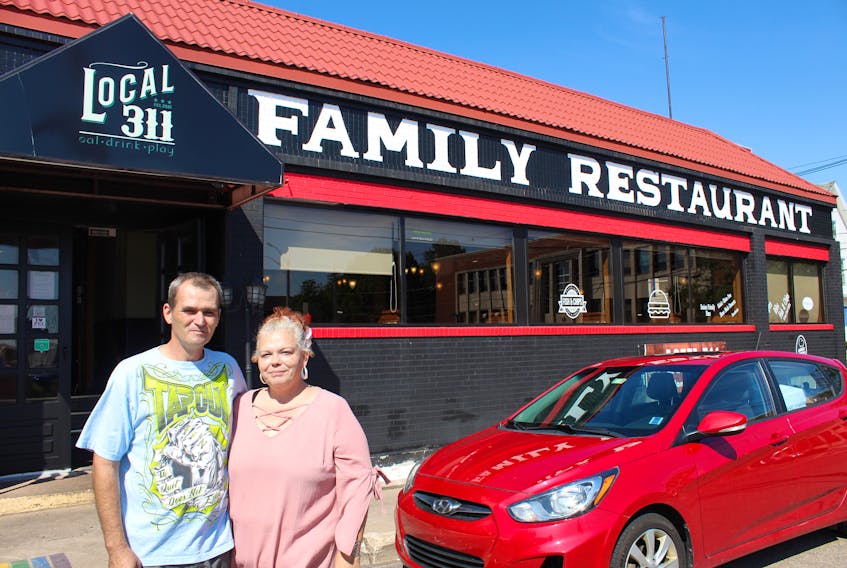 MJ Doyle and Dave Ashford stand in front of Local 311, the Summerside restaurant of which they took over ownership. Owning a busy family restaurant has been their dream.