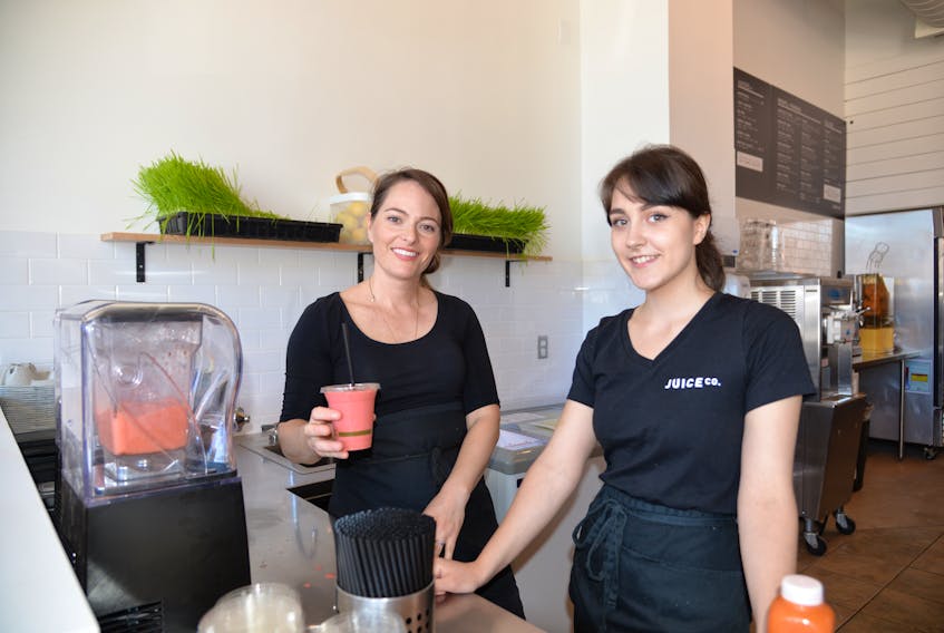 Sharie Hughes, left, co-owner of Juice Co., and Tori Martin, make a smoothie for a customer on Friday at the business’s new downtown Charlottetown location at 133 Queen St.