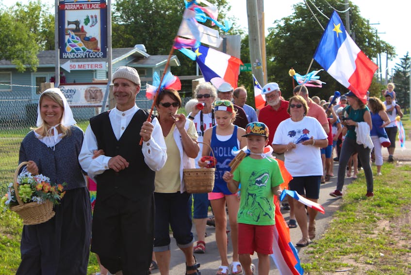 The traditional Acadian characters of Evangeline and Gabriel lead a tintamarre or "noise parade" through Abram-Village on National Acadian Day in this file photo.