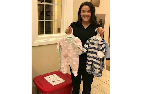 Alyssa Pinsent holds up recent donations of newborn sleepers at Andrews of Charlottetown where she is accepting and donating the sleepers to the Queens Elizabeth Hospital.