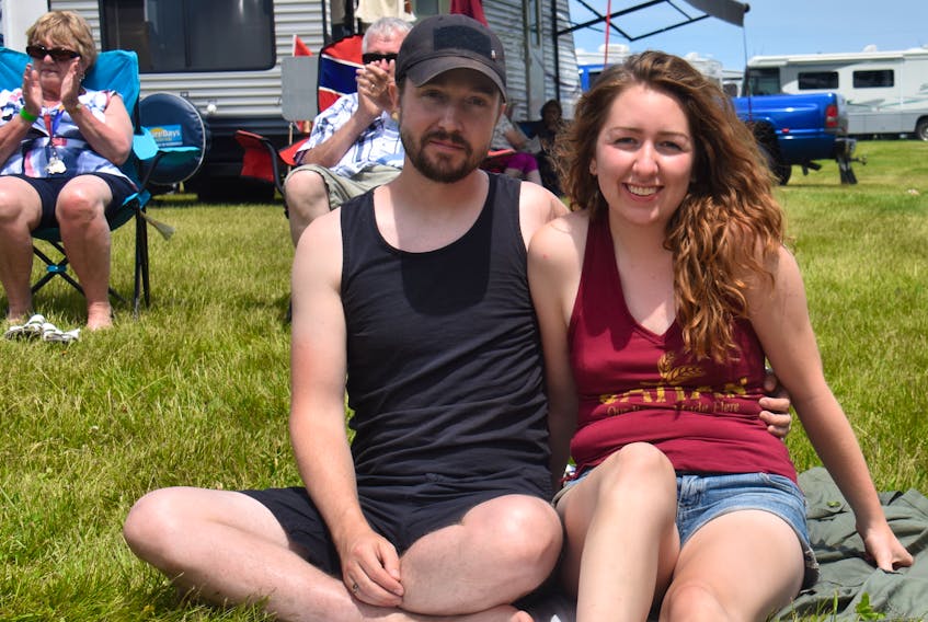 Natasha Pentyliuk and Colin Bodor sit in the grass enjoying the Bluegrass and Old Time Music Festival this past Sunday. The couple stumbled upon the festival while Pentyliuk was visiting P.E.I. taking a break from her work in Yarmouth, N.S.