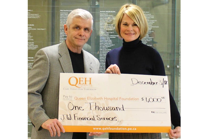 John McAleer, left, J.W. Financial Services, presents Julie Hambly, right, Queen Elizabeth Hospital Friends for Life campaign chairwoman, with a $1,000 donation. This gift will support the purchase of a new CT scanner and post-processing technology, used in almost every aspect of medicine especially as it relates to stroke care, cancer care, and major trauma.