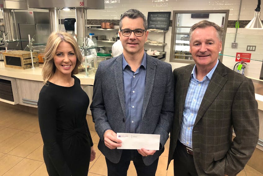 Michael MacKinnon, centre, managing director of Red Shores Racetrack and Casino, presents a donation of $10,000 to Jo-Ann Campbell-Boutilier, executive director of the Holland College Foundation, and Ron Keefe, board chairman. The gift, designated to the Nourish campaign, will help to revitalize the Culinary Institute of Canada. Submitted photo