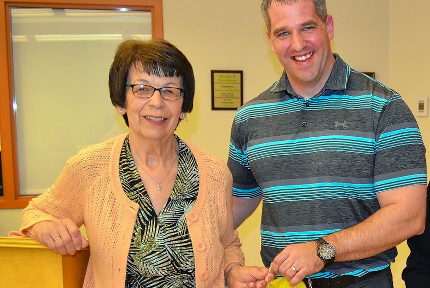 Paul Young, administrator of Community Hospitals West, receives a gift of appreciation during the annual meeting of the O’Leary Community Health Foundation from  executive member Eva Rodgerson. Also on hand for the presentation were Fairley Yeo and Eileen Brown.