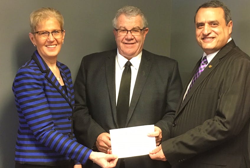 Ken Clark, centre, presents a $1 million gift on behalf of the estate of his aunt, Ruth MacDonald, to UPEI president Alaa Abd-El-Aziz and executive director of development and alumni engagement Myrtle Jenkins-Smith.