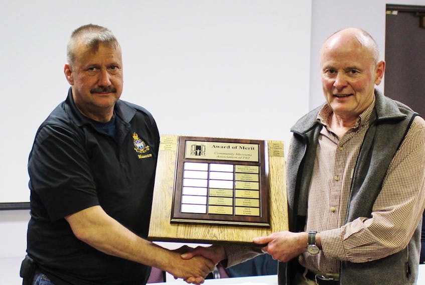Greg Gallant, left, president of the Community Museums Association of P.E.I., presents the CMAPEI annual Award of Merit to Doug Sobey for his work with the Bedeque Historical Society.