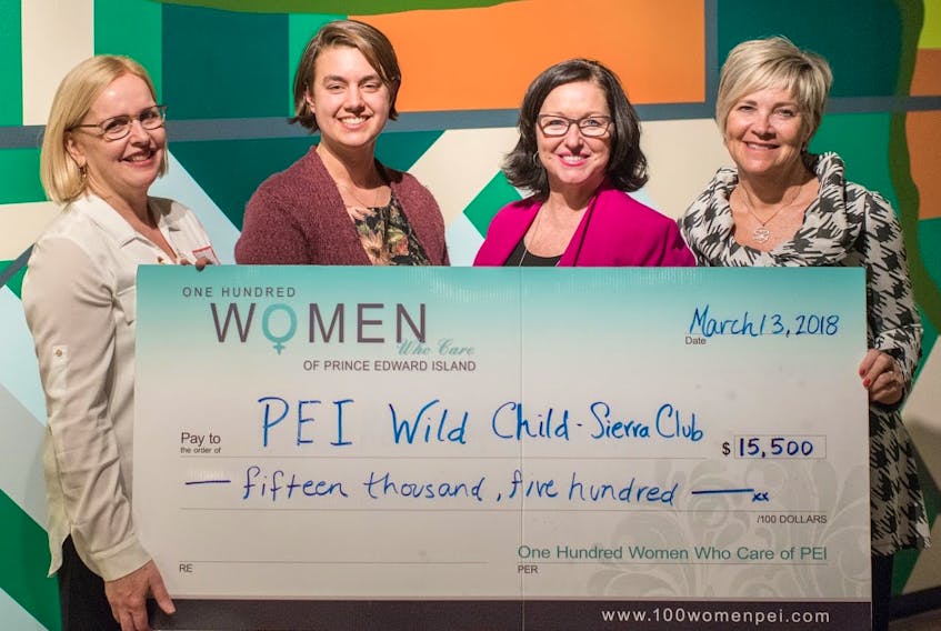 Hannah Gehrels, programs co-ordinator for Sierra Club Wild Child P.E.I., accepts a cheque from Aileen Matters, left, Kathleen Casey and Valerie Docherty, right, following a recent meeting of 100 Women Who Care P.E.I.
