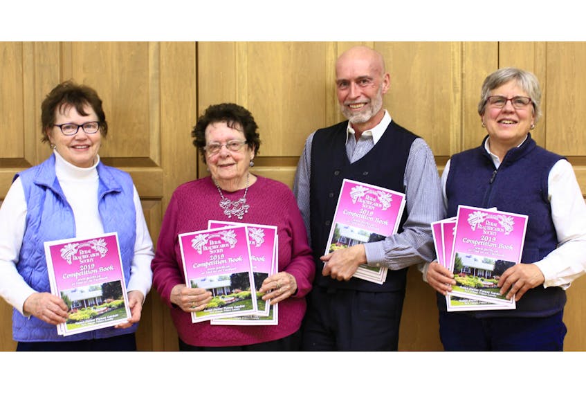 Curtis Crozier, left, Janet Cotton, Garth Davey, president, and Liz Spangler, board members of the P.E.I. Rural Beautification Society, display the 2019 Competition Book. The books are now being distributed throughout many areas of rural P.E.I.