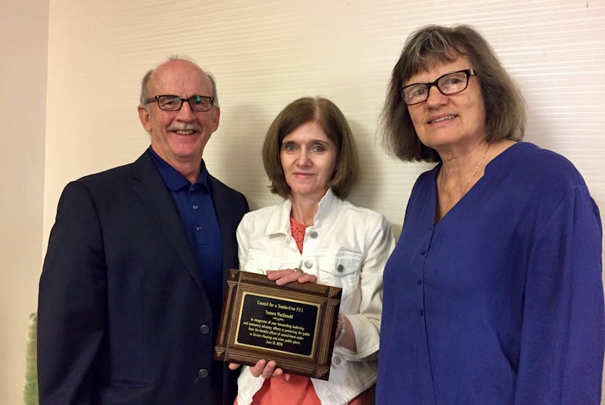 The Council for a Smoke-Free P.E.I. has paid tribute to Tamara MacDonald, centre, for her leadership and community advocacy efforts in protecting the public from the harmful effects of second-hand smoke. On hand for the plaque presentation were council members Shirley Jay, president, and Frank Morrison.