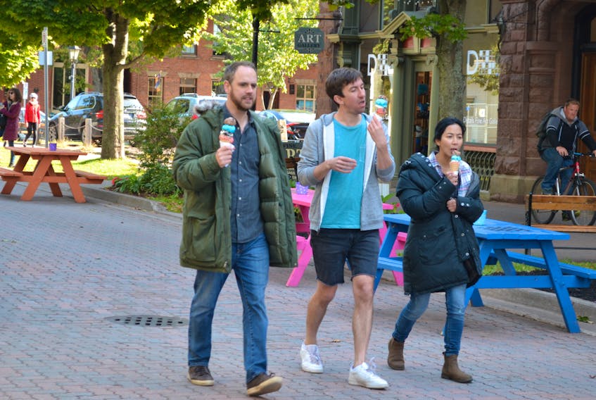 Andrew Bush, left, Mark Little and Zoé Doyle rehearse a scene for “Cavendish” on Victoria Row in Charlottetown, this past summer. In this scene Little's character loses his ice cream, when it falls on the cobblestones. It took five takes and five trips to the Cows ice cream shop to finish the scene.