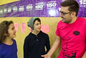 Amani Taleb, left, and Jacob Katmouz chat with national Pink Shirt Day co-founder Travis Price.