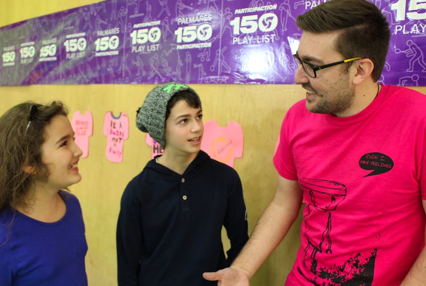 Amani Taleb, left, and Jacob Katmouz chat with national Pink Shirt Day co-founder Travis Price.