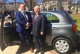 Donor Lou MacEachern, right, congratulates business administration student Aaron King after he was awarded the keys to a 2019 Nissan Micra.