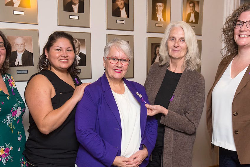 Jillian Kilfoil, left, of Women's Network P.E.I., is shown with Samantha Lewis, Aboriginal Women's Association of P.E.I., Transportation, Infrastructure and Energy Minister Paula Biggar, Sigrid Rolfe of the P.E.I. Rape and Sexual Assault Centre and Ellen Mullally of the Community Legal Information Association.