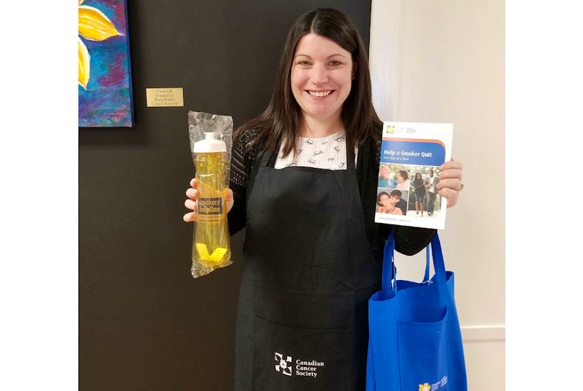 Gina Burke, program administrator, Canadian Cancer Society, holds a Quit Kit that will be given out to participants in the Cooking to Quit program, which will be launched next month by the Canadian Cancer Society.
